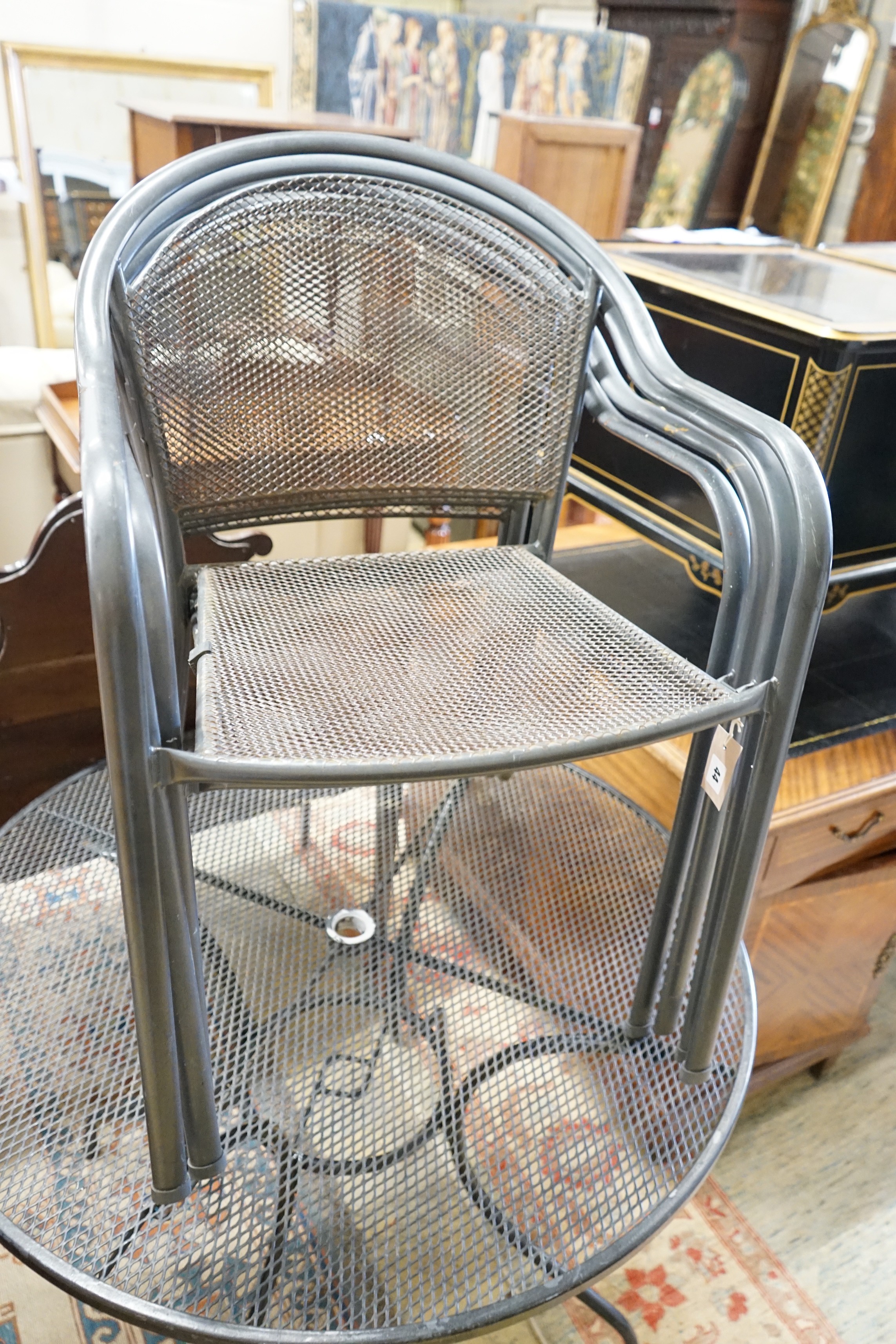 A circular aluminium garden table, diameter 100cm, height 72cm and four matching stacking chairs